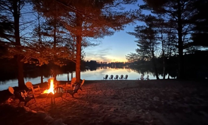 Evart House | Lakefront Retreat with Sandy Beach and Family-Friendly Amenities
