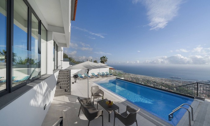 Monte Villa | Experience Monte White House: Balcony Views & Spa Retreat