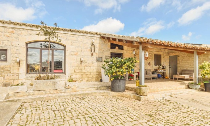 Modica House | A cottage decorated in country style with rustic details.