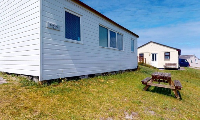 Hayle Apartment | A traditional beach chalet vibe, and outdoor seating with views toward St. Ives Bay