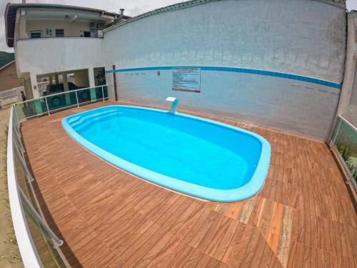 Maranduba Apartment | Experience a Poolside Retreat with Ocean Views and BBQ