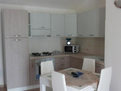 La Muddizza Apartment | Pet-Friendly Appartamenti Isola Rossa with Ocean View Pool