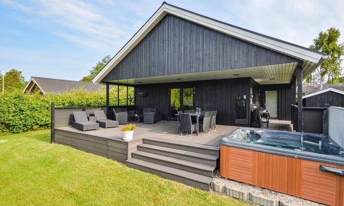 Hejlsminde Strand House | Quaint Wooden Retreat with Scenic Views and Garden Oasis