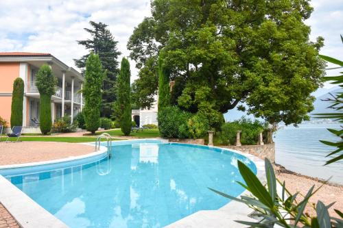 Porto Ceresio Apartment | Lakefront Escape: Apt. 123 with Private Beach and Pool