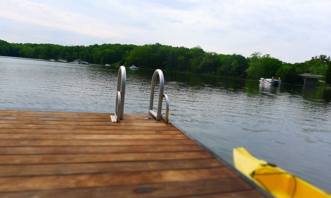 Wolf Creek House | Inviting Waterfront Dock with Pool and Lake View Amenities