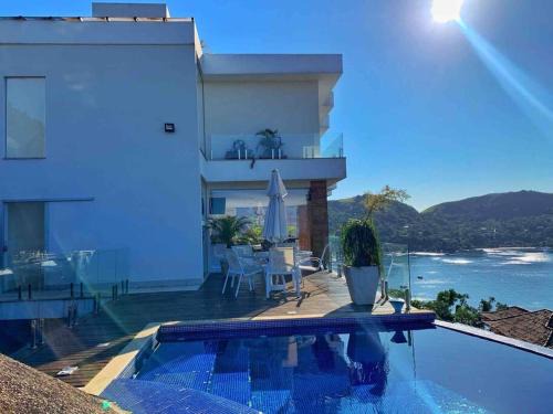 Portogalo House | Experience Spectacular Views and Poolside Relaxation in Angra