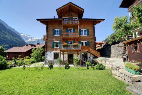 Champery House | Elegant Chalet Eden Duplex with Garden and Swedish Stove