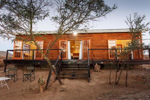 Oudtshoorn Cabin | Comfortable Chandelier Game Lodge with Hot Tub & Restaurant