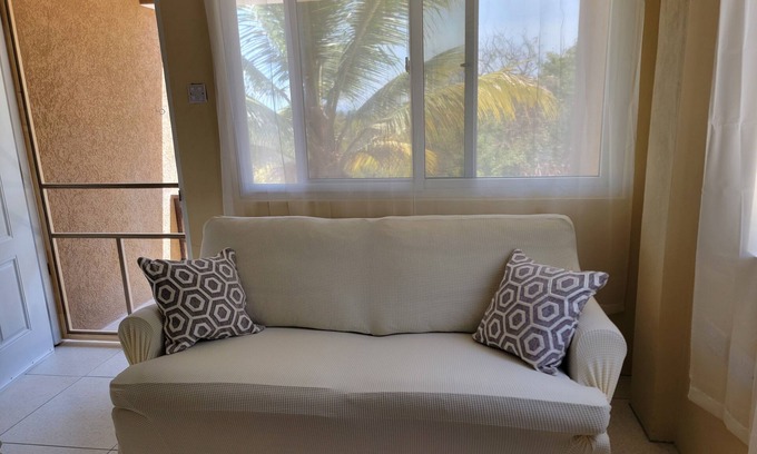 Crochu Apartment | Charming 2-bedroom hideaway near Cabier, full kitchen and air-conditioned rooms.