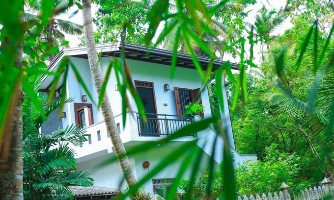 Weligama Cabin | Inviting Dark Lodge by the River with Family-Friendly Amenities