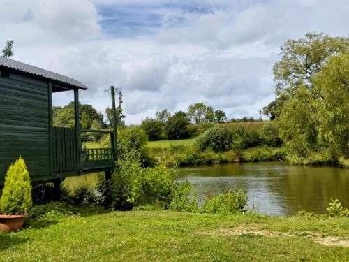 Hadlow Down House | Tranquil Shepherds Hut with Lakeside Balcony & Pool Access