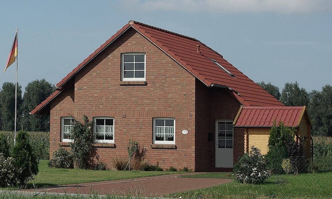Krummhoern House | Stylish Friesenhaus with Waterfront Jetty and Family Amenities