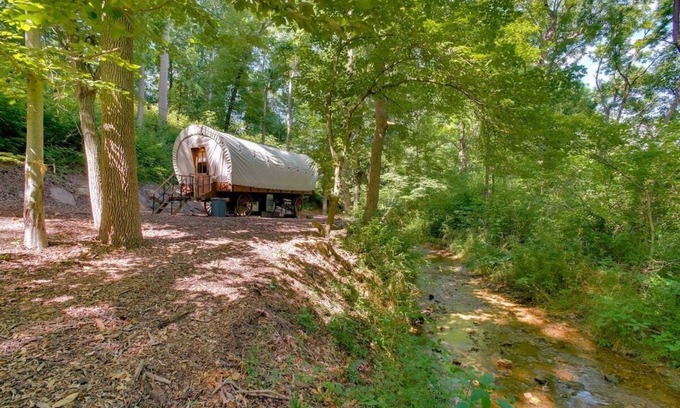 Strasburg RV Rental | Idyllic Covered Wagon Camping Experience by the Creek