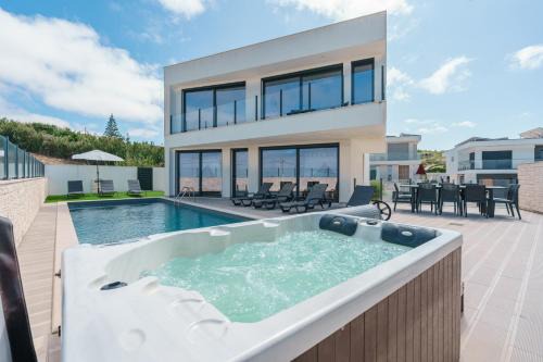 Ribamar Villa | Discover Dino Villa: Oceanfront Escape with Hot Tub & Pool