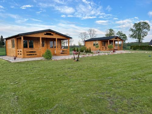 Małdyty Cabin | Discover Domki nad stawem: Oceanfront Retreat with Pool