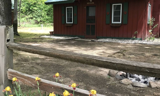 Grawn Cabin | Relaxing Ellis Lake Resort Elm Log Cabin with Spa & Hot Tub