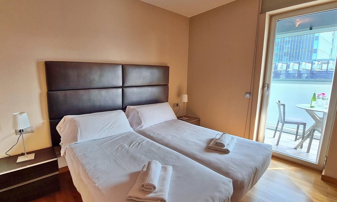 El Port Apartment | Elegant Apartment Steps from Fira Gran Via with Unique Amenities