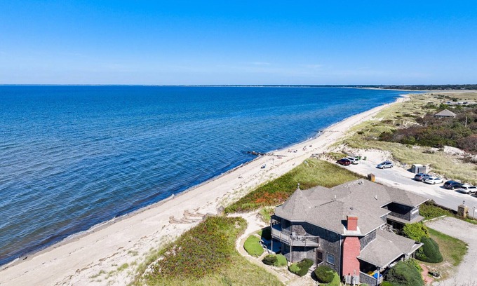 Brewster Apartment | Escape to this rare beachfront retreat where the sea is your front yard
