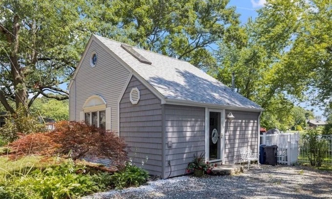 Warwick Cottage | Freshly renovated waterfront retreat in Warwick Cove! This cozy 1-bedroom features a loft-style king bed, queen sleeper sofa, spacious deck, fenced yard, and open backyard leading to the water - perfect for a relaxing coastal escape.