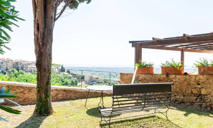 Castagneto Carducci Apartment | Enchanting Garden Apartment with Sea View in Medieval Village
