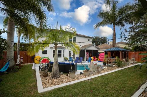 Tropic House | Urban Oasis with Hot Tub, Heated Pool & Private Theater