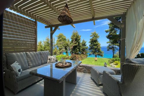 Achinos Apartment | Tranquil Green and Blue View with Oceanfront Amenities