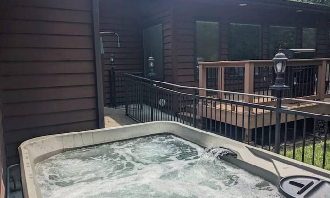 Manhattan House | Hot Tub and Game room! Center of Town, walking distance to ball games & College.