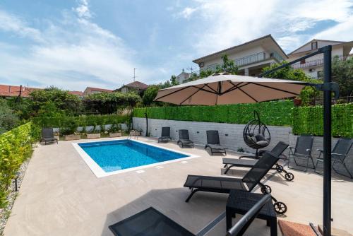 Seget Vranjica Apartment | Escape to House Antonija: Relax by the Oceanfront Pool