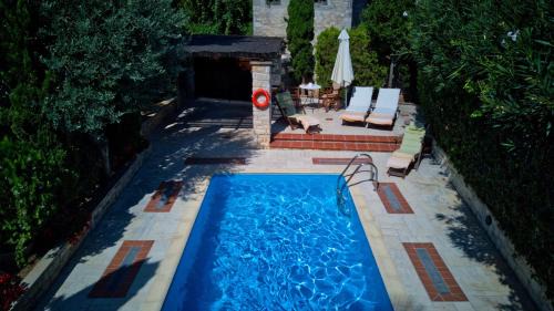 Afytos Villa | Elegant Katsaneiko Mansion: Oceanfront Retreat with Pool