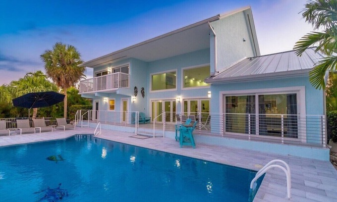 Coury House | Pet-Friendly Aqua Vista: Waterfront Oasis with Pool & Dock
