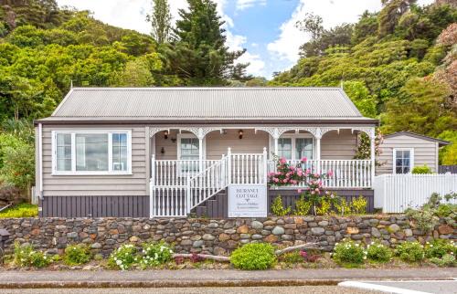 Thames House | Exceptional Kuranui Cottage with Oceanfront Spa & Hot Tub