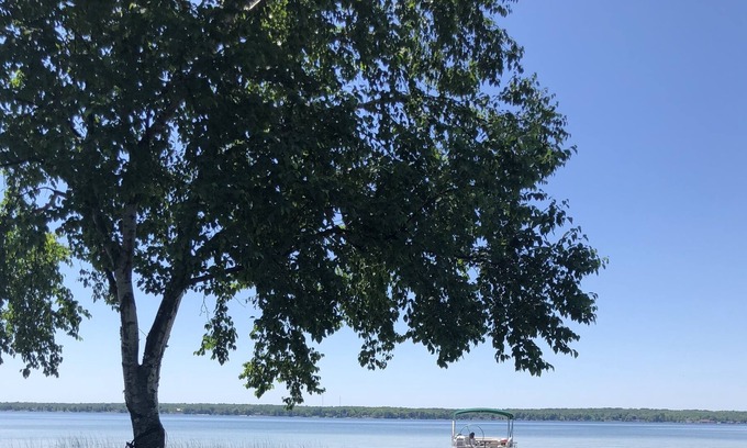 Alpena House | Lakefront getaway w/ treehouse, hot tub, 20 foot pontoon, gym