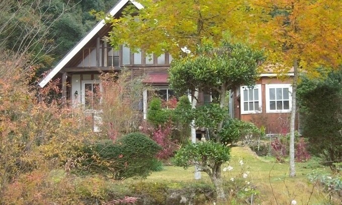 Hata-gun Cottage | Idyllic Log Guest House with Expansive Lawn & Spa Retreat