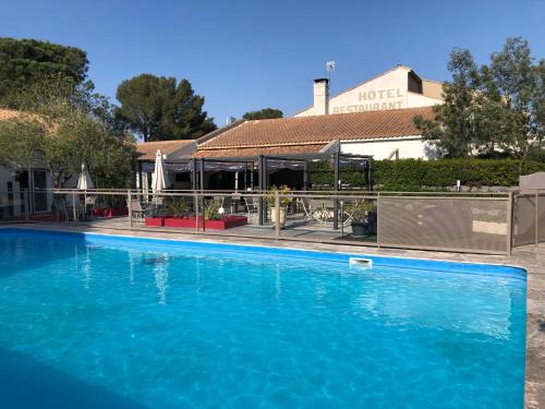 Caissargues Hotel | Inviting Logis Hôtel Restaurant Les Aubuns with Pool & Ocean Views