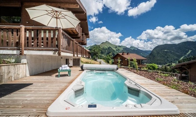 La Cote-d'Arbroz Ski Chalet | Lovely wooden balconies, a swing chair with the most picturesque view