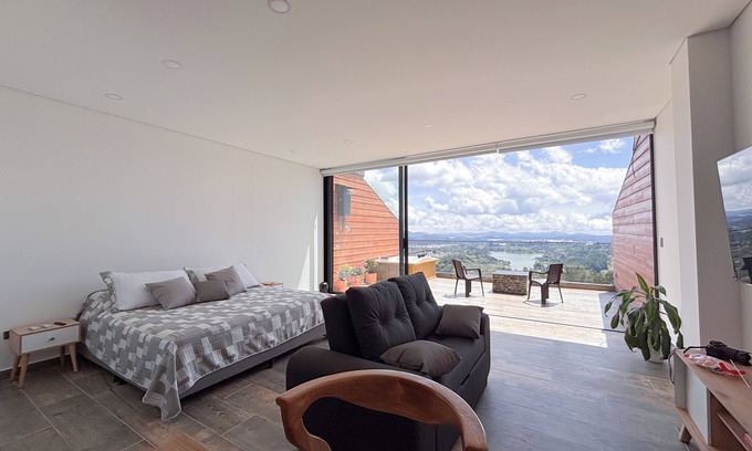 El Penol Apartment | Luxury Stay with Fireplace, Jacuzzi & Overlooking the Rock of El Peñol-Guatape