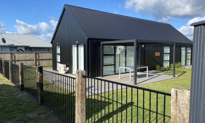Matarangi House | Chic Oceanfront Industrial Barn with Breakfast & Family Amenities