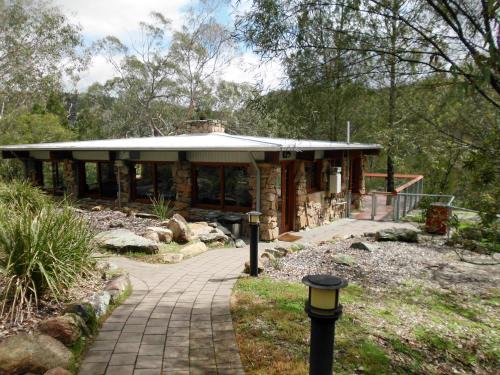 Warrabah House | Muluerindie: Stylish Retreat with Hot Tub & Kitchen Access