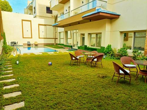 Sheikh Zayed City Apartment | Experience My Villa: 4-Star Stay with Pool & Breakfast