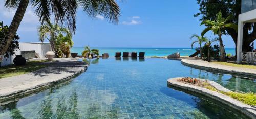 Pereybere Hotel | Ocean Beauty: Relax by the Private Beach and Poolside Haven