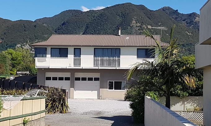 Pohara House | Only steps from the beach. Roomy, relaxed family fun. Good old Kiwi bach.