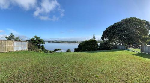 Te Kopuru House | Tranquil Riverfront Cottage with Ocean View & Pet Friendly