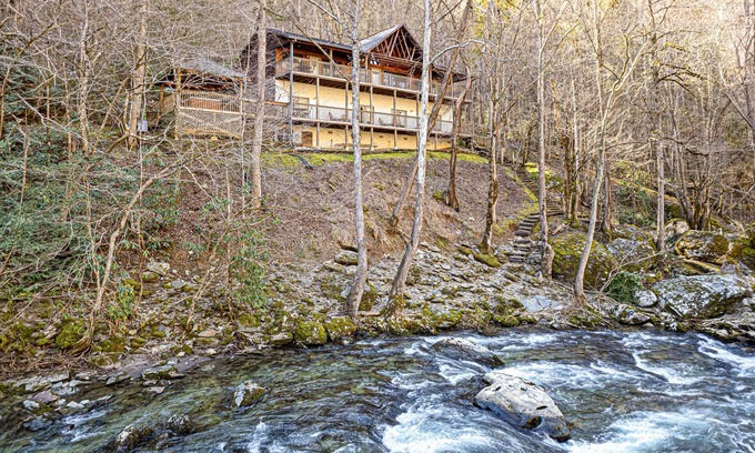 Gatlinburg - Pigeon Forge Cabin | Tranquil River View Retreat with Firepit & Hot Tub Awaits
