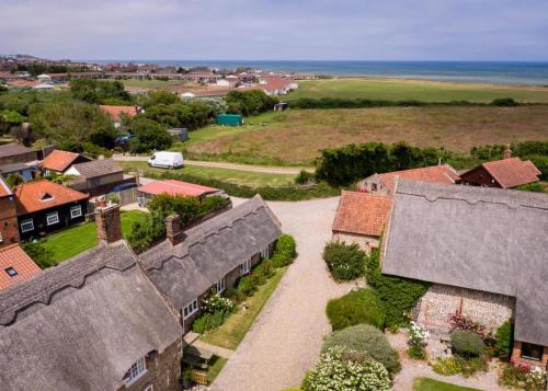 Bacton House | Discover Pilgrims Cottage: Pet-Friendly Retreat with Pool