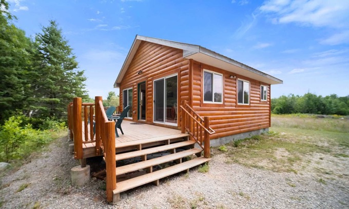 Carp Lake Cabin | Lakefront Log Cabin with Pool & Family-Friendly Amenities
