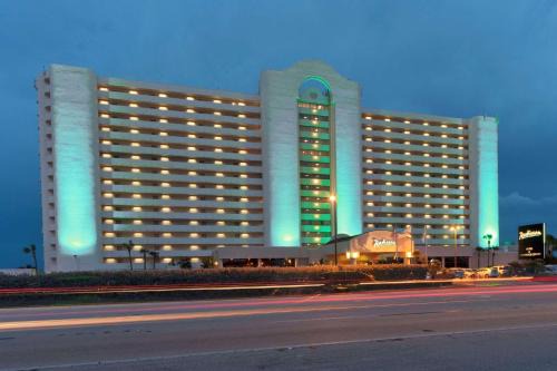 Canova Beach Hotel | Oceanfront Bliss at Radisson Suite Hotel with Pool & Dining