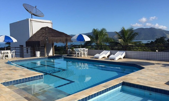 Lagoinha Apartment | Relax at Kendy Flats: Rooftop Pool & Ocean Views Await