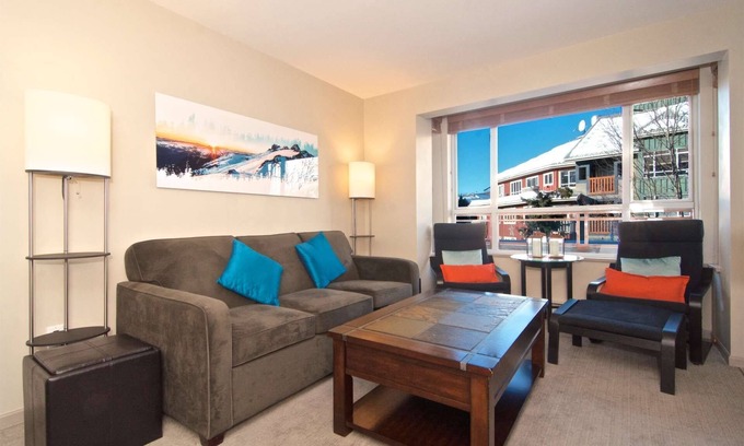 Village North Condo | Relax on the Oversized Patio with Village Views & Great Amenities