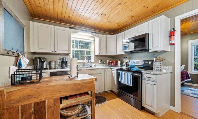Cherry Log House | Pet-Friendly Riverfront Retreat with Game Room & Hot Tub