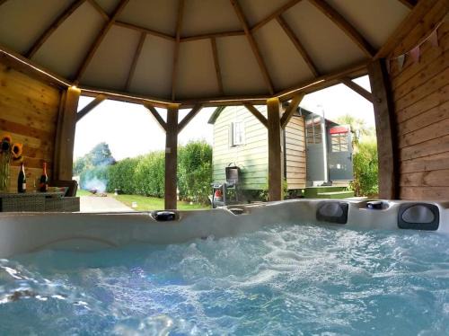 Camborne House | Romantic Getaway: Shepherds Hut with Hot Tub Awaits!